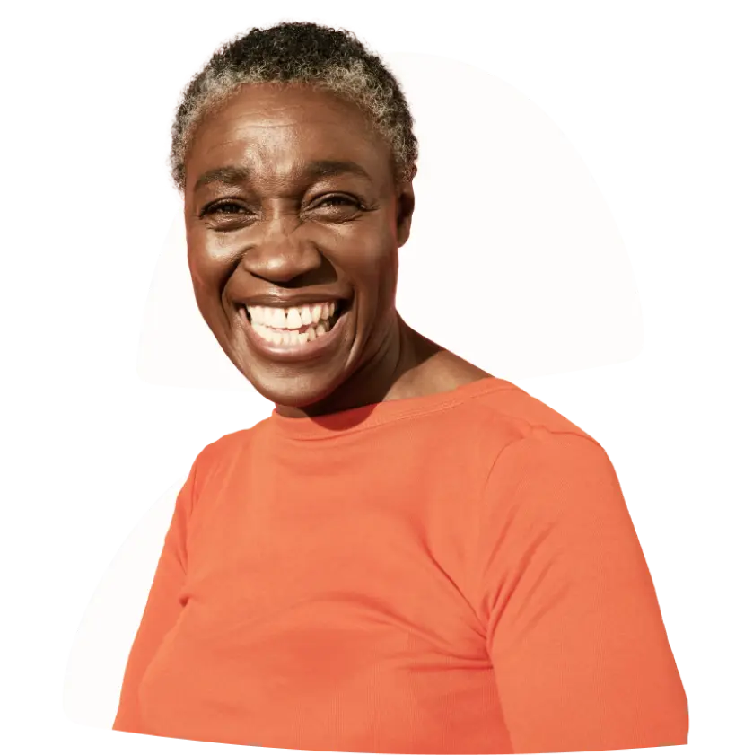 A very happy lady in an orange shirt